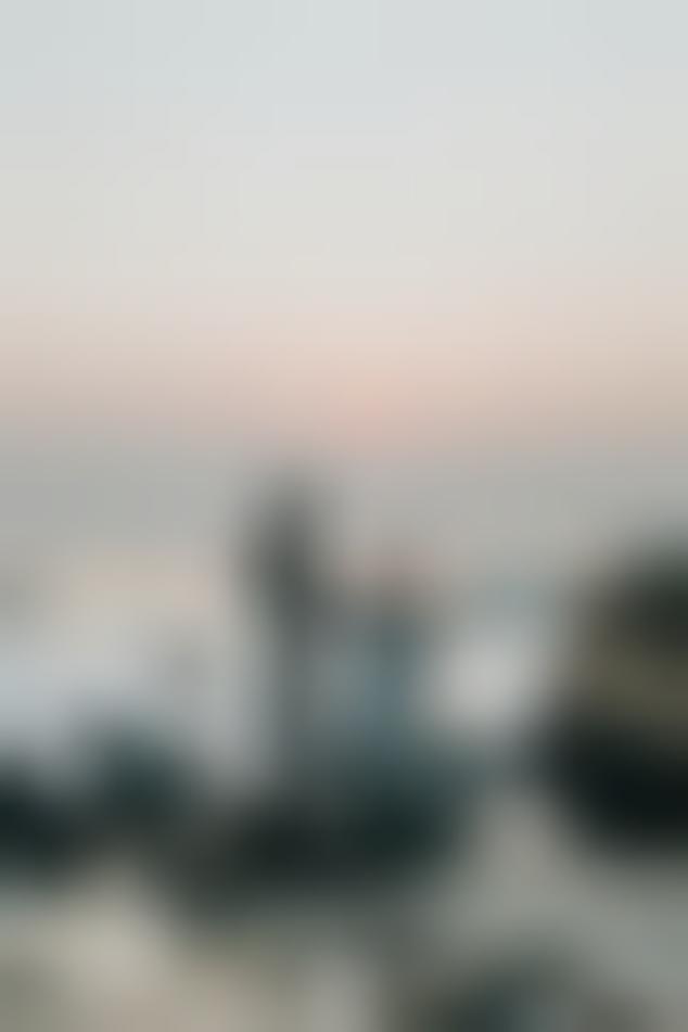 Man proposing to a woman on the beach at sunset.