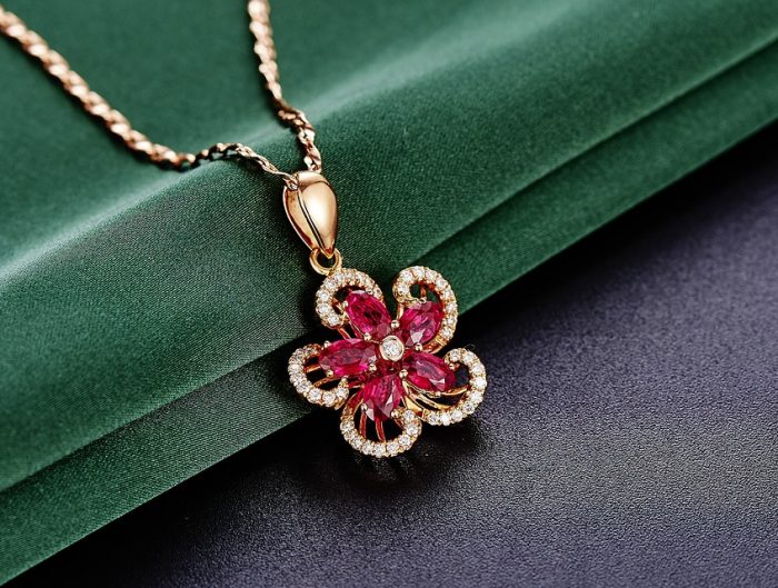 Yellow gold flower necklace set with rubies and diamonds.