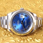 Pre-owned men’s Rolex Datejust in stainless steel with a blue dial and roman numeral markers.