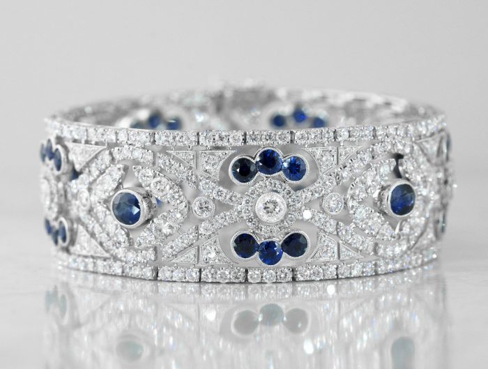 White gold wide cuff bangle set with diamonds and blue sapphires.