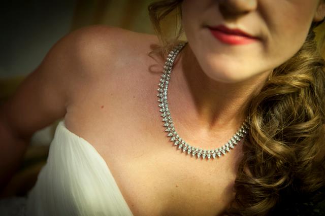 White gold diamond tennis necklace on bride's neck.