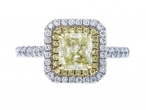 White gold engagement ring centered with a fancy yellow diamond, surrounded by a
double halo of diamonds, and diamonds in the band.