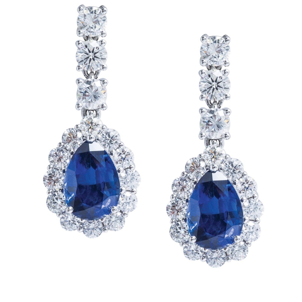 White gold drop earrings set with blue sapphires and diamonds.