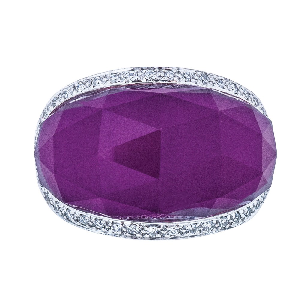 White gold statement ring centered with purple gemstone surrounded by diamonds.