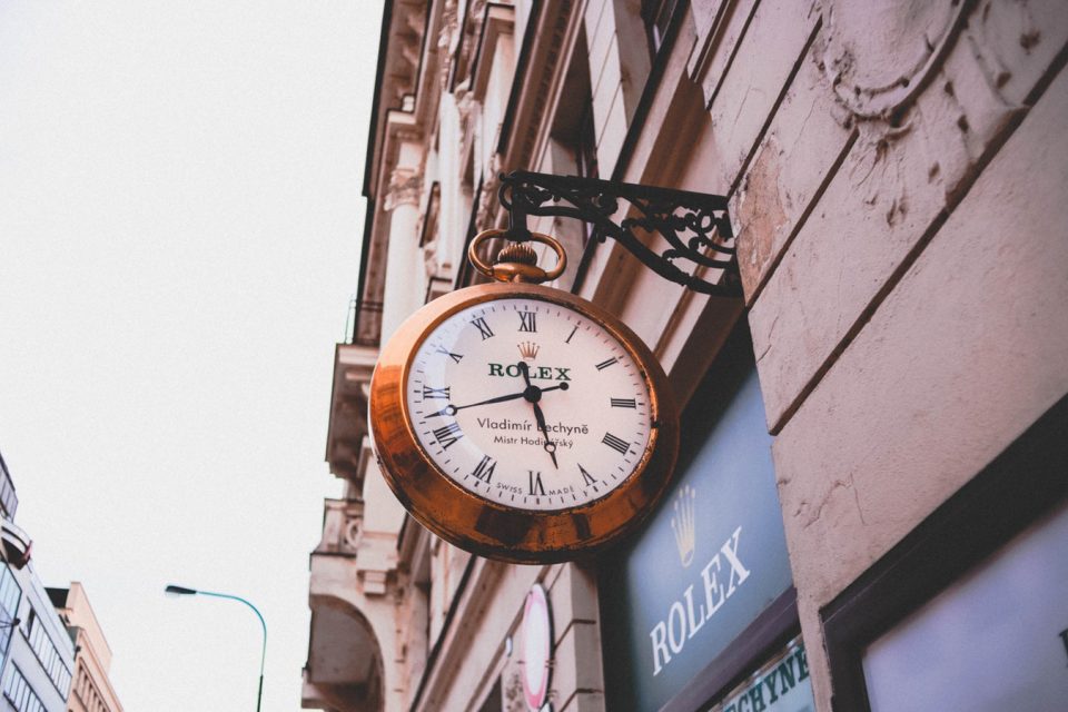 Outside of a retail Rolex store featuring their building Rolex clock.