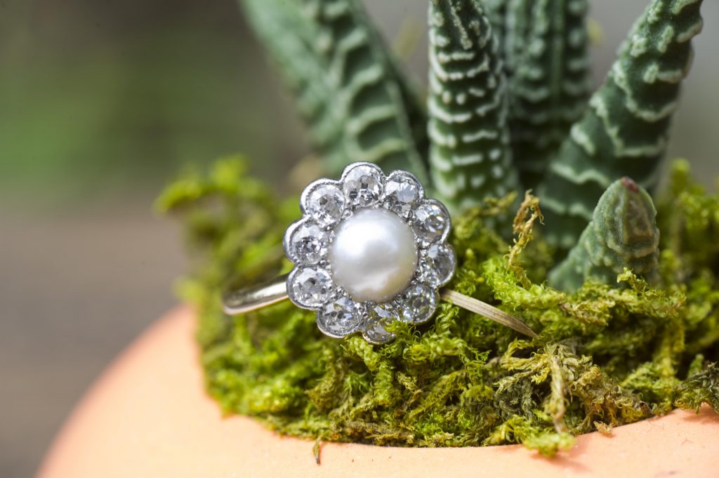 Antique platinum diamond and pearl engagement ring.