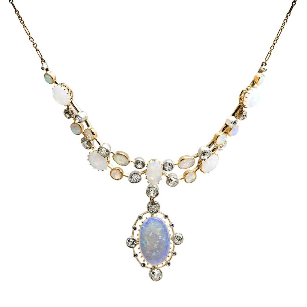 Yellow gold and white gold drop necklace centered with an opal surrounded by opals and
diamonds.