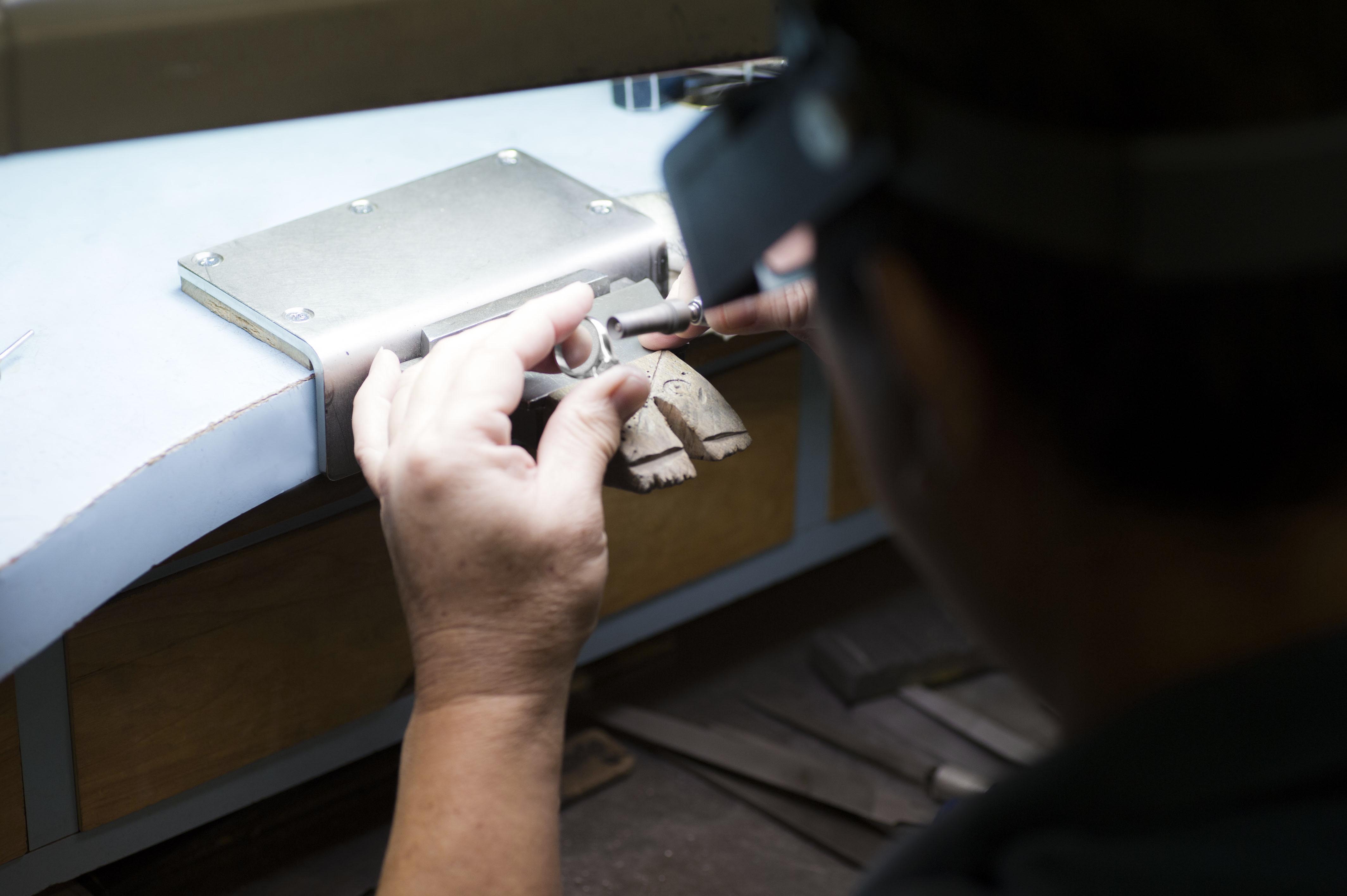 Jeweler working on repair at their bench.