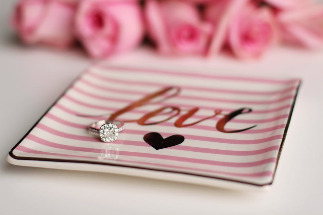 Diamond engagement ring on a jewelry tray.