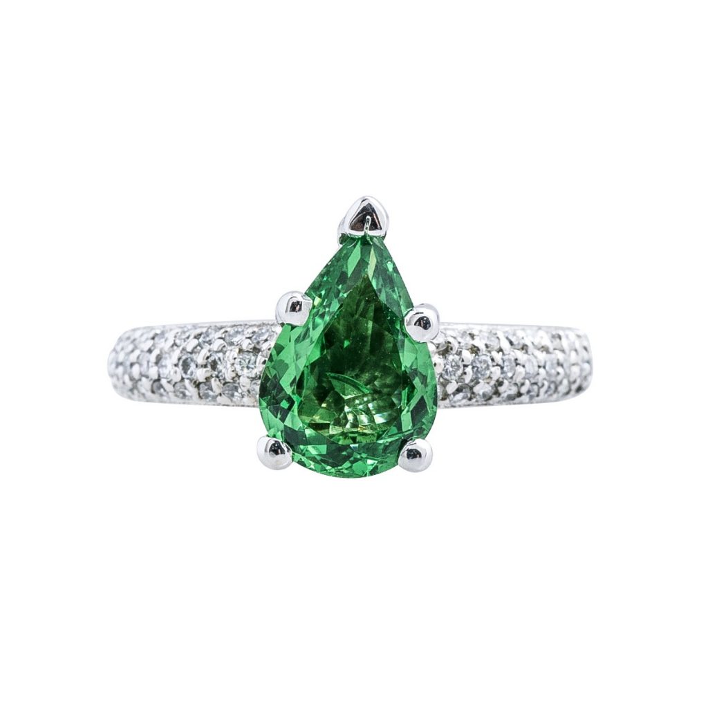 White gold engagement ring centered with tsavorite garnet and diamonds in the band.