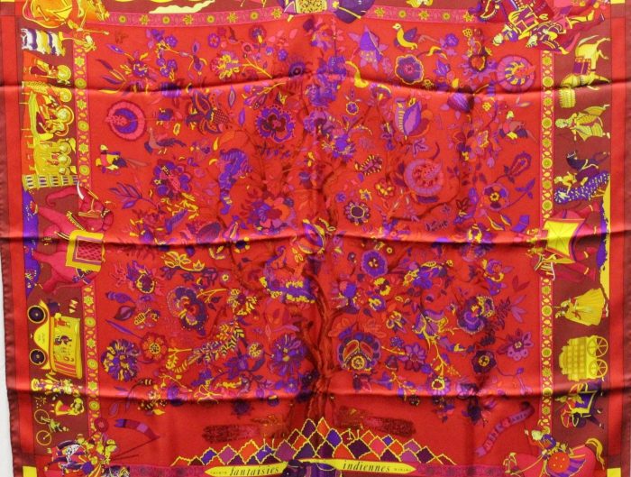 Vintage Hermès scarf in red with African animal border and floral center.