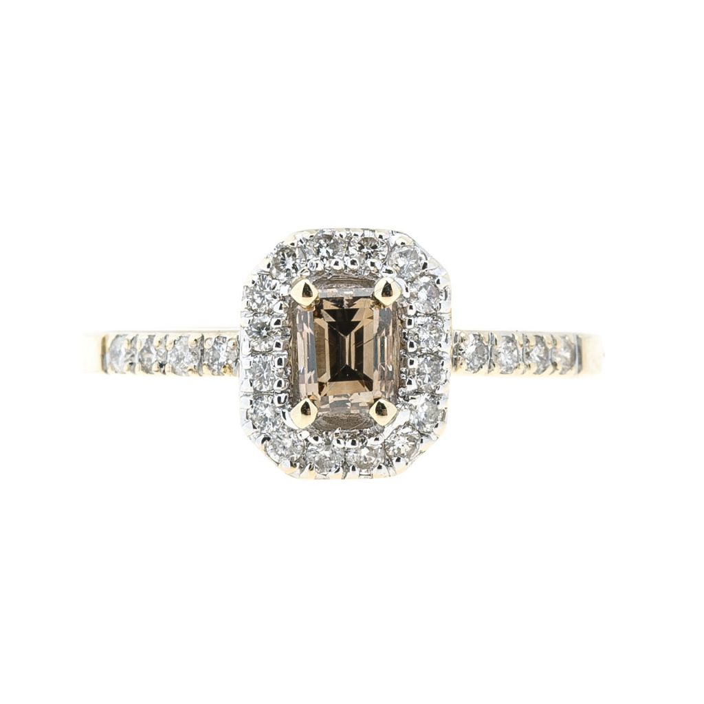 Yellow gold engagement ring centered with a cognac diamond surrounded by a white diamond halo and white diamonds in the band.