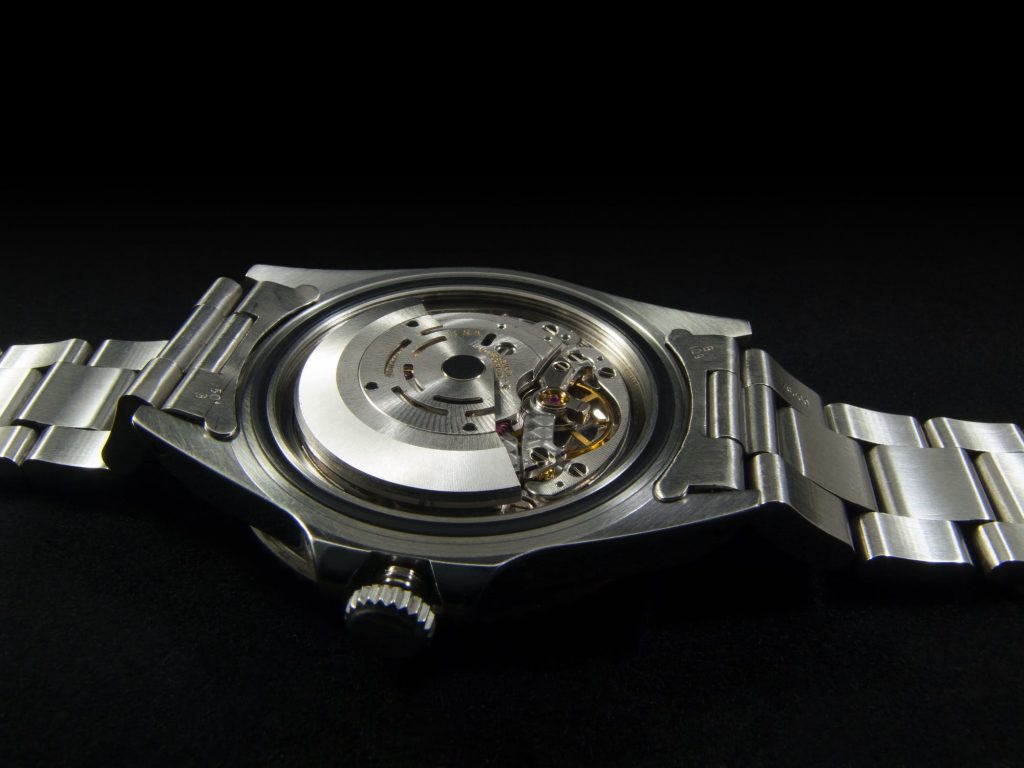 Stainless steel watch showcasing the exhibition case back.