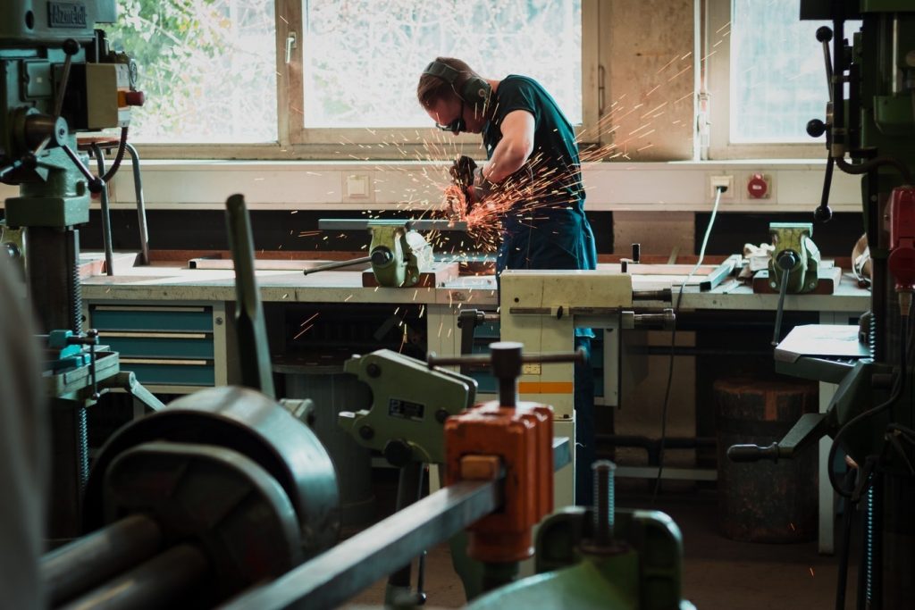 Jewelers working at their bench in a jeweler’s room.