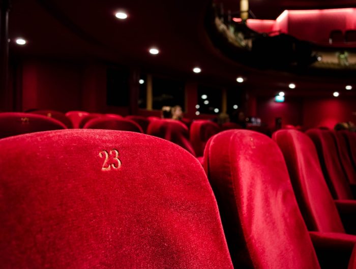 Row of red movie theater seats.