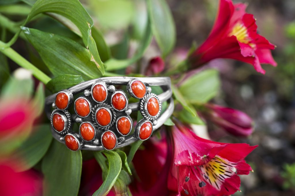 Sterling silver cuff bracelet set with orange gemstones.