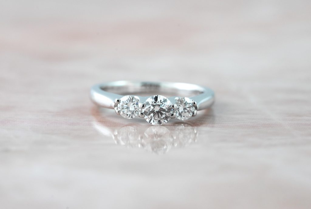 White gold three-stone engagement ring set with diamonds.