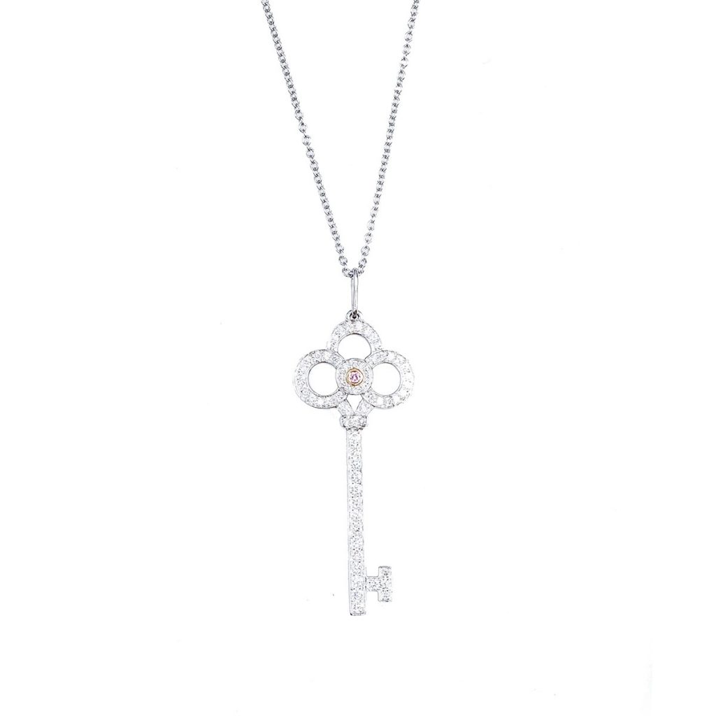 White gold key pendant set with diamonds.