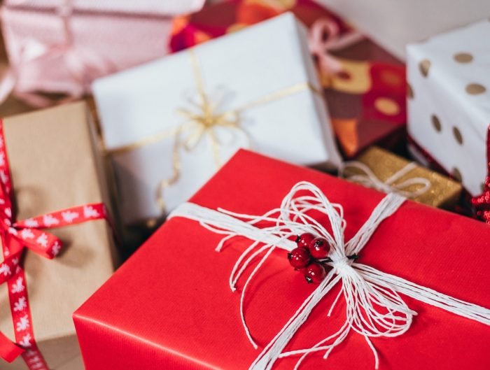 Several wrapped presents with Christmas ribbon.