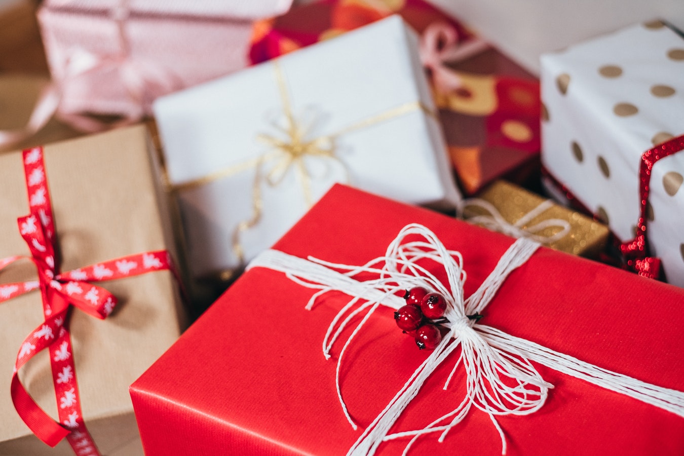 Several wrapped presents with Christmas ribbon.