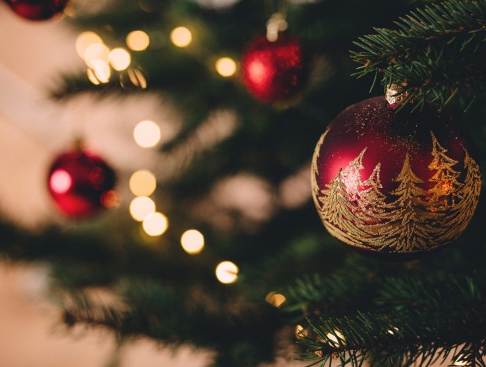 Close-up of a Christmas tree with red ornaments.