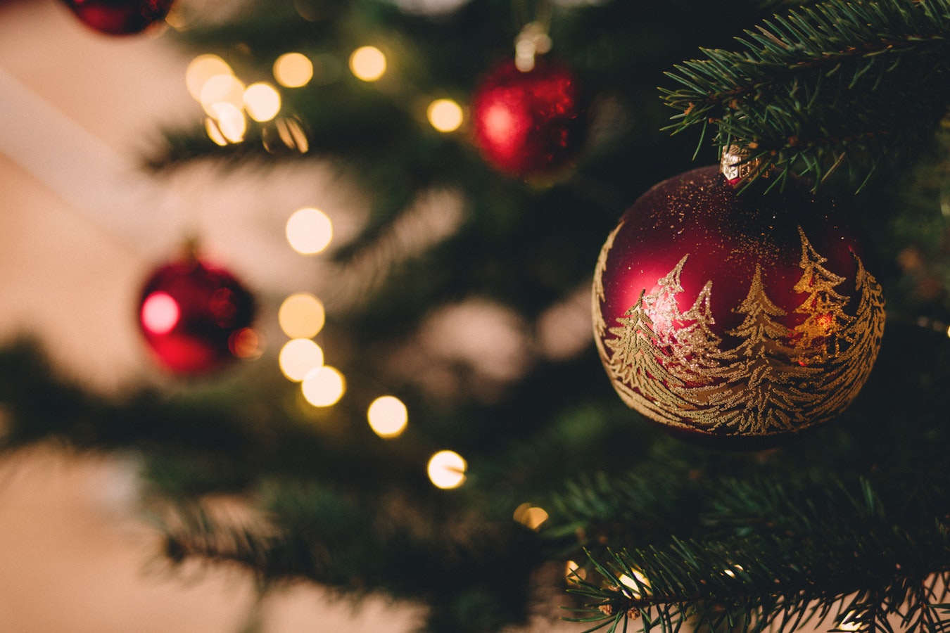 Close-up of a Christmas tree with red ornaments.