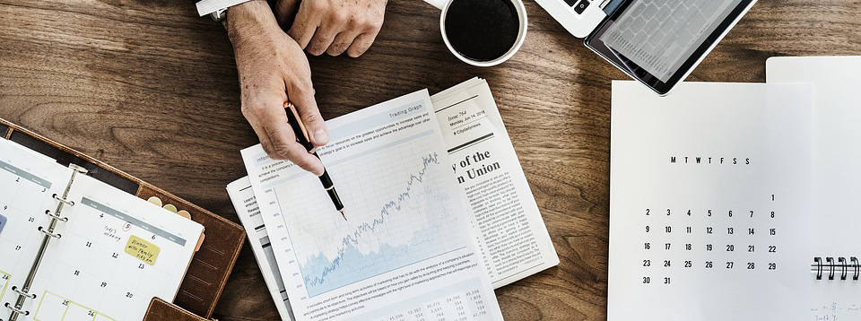 Investment trends paperwork laid out across desk.