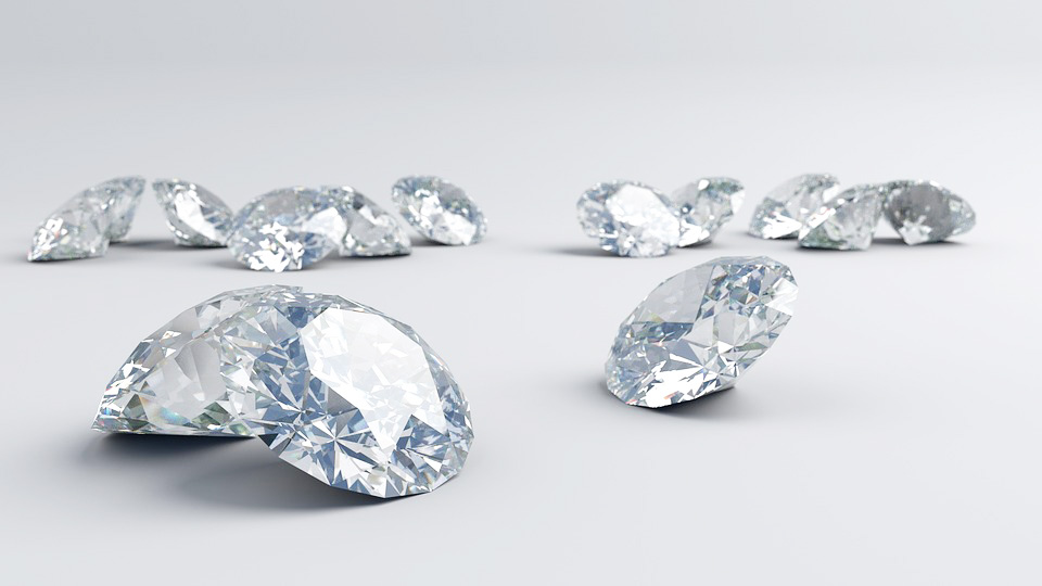 Several loose round cut diamonds on white background.