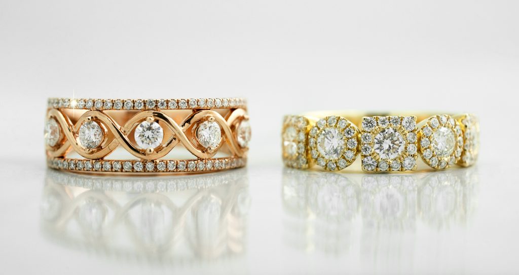 Yellow gold and white gold eternity bands both set with diamonds.