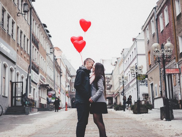 a couple kissing in the middle of a street