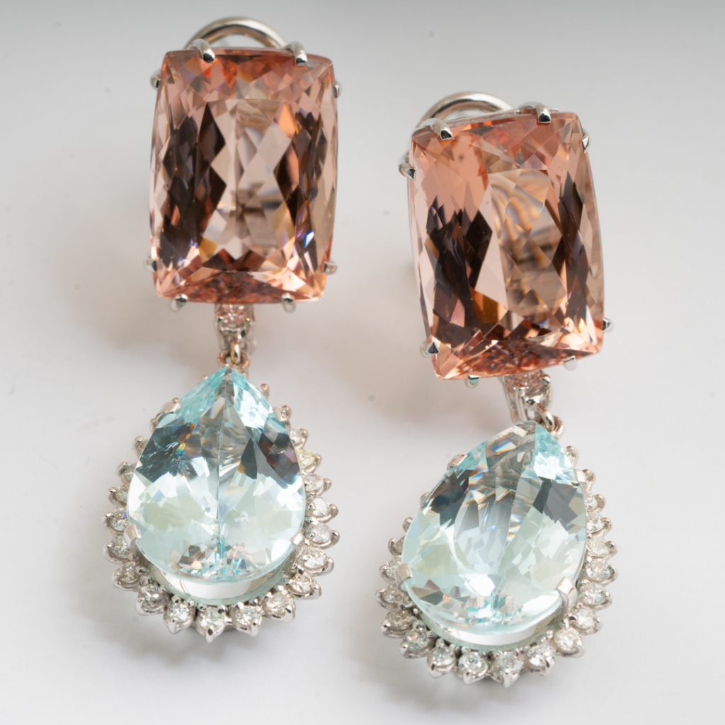 White gold drop earrings set with morganite and aquamarine surrounded by diamond haloes