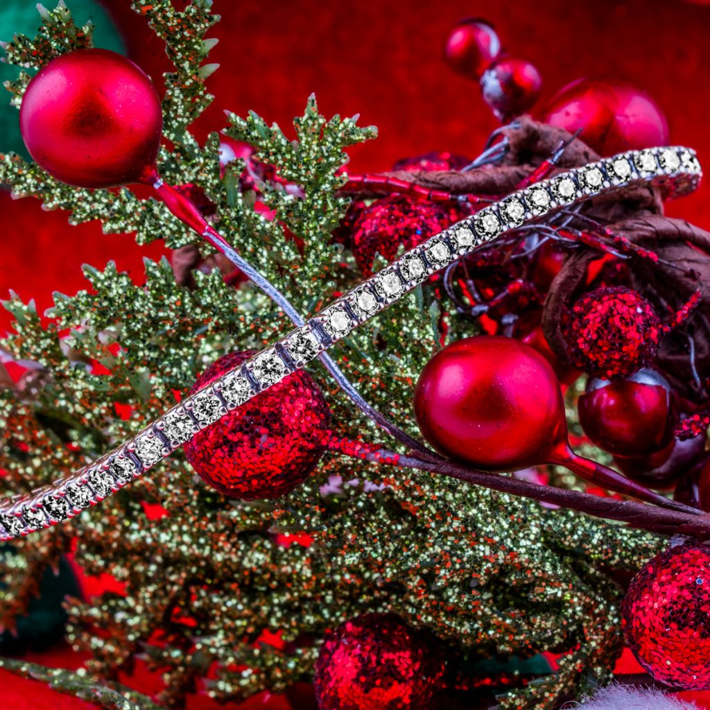 New lab-grown diamond tennis bracelet displayed around mistletoe.