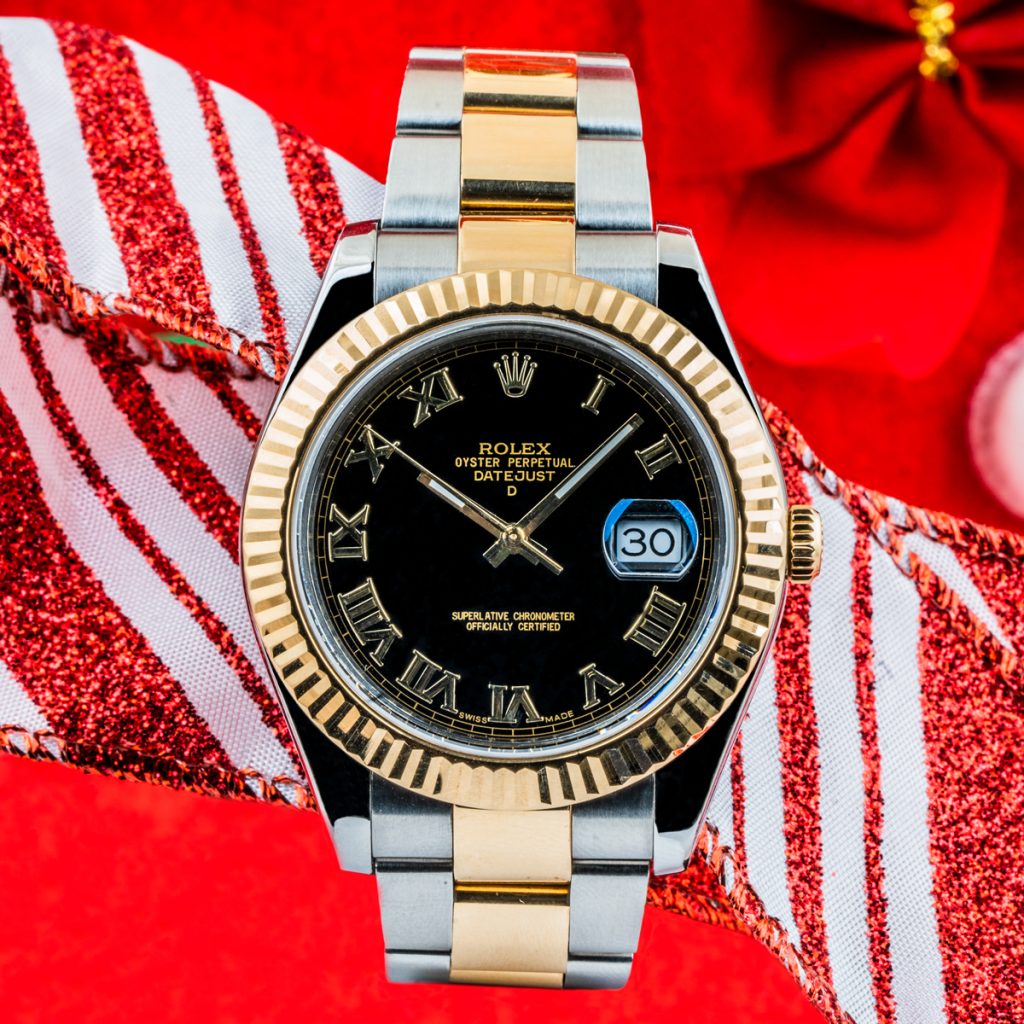 Pre-owned men’s Rolex Datejust II 41mm on a red and white striped ribbon background.