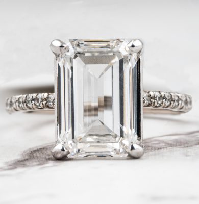 White gold engagement ring centered with a lab-grown diamond and diamonds in the band.