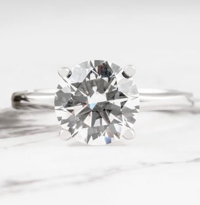 White gold solitaire engagement ring set with a lab-grown diamond.