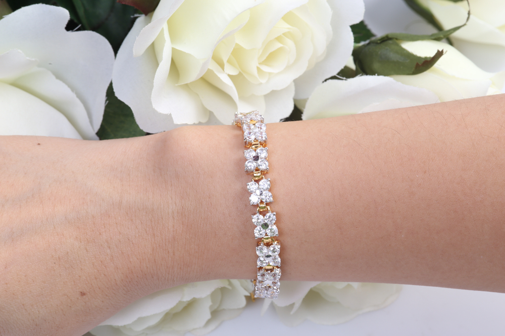 diamond and gold flower bracelet worn on wrist