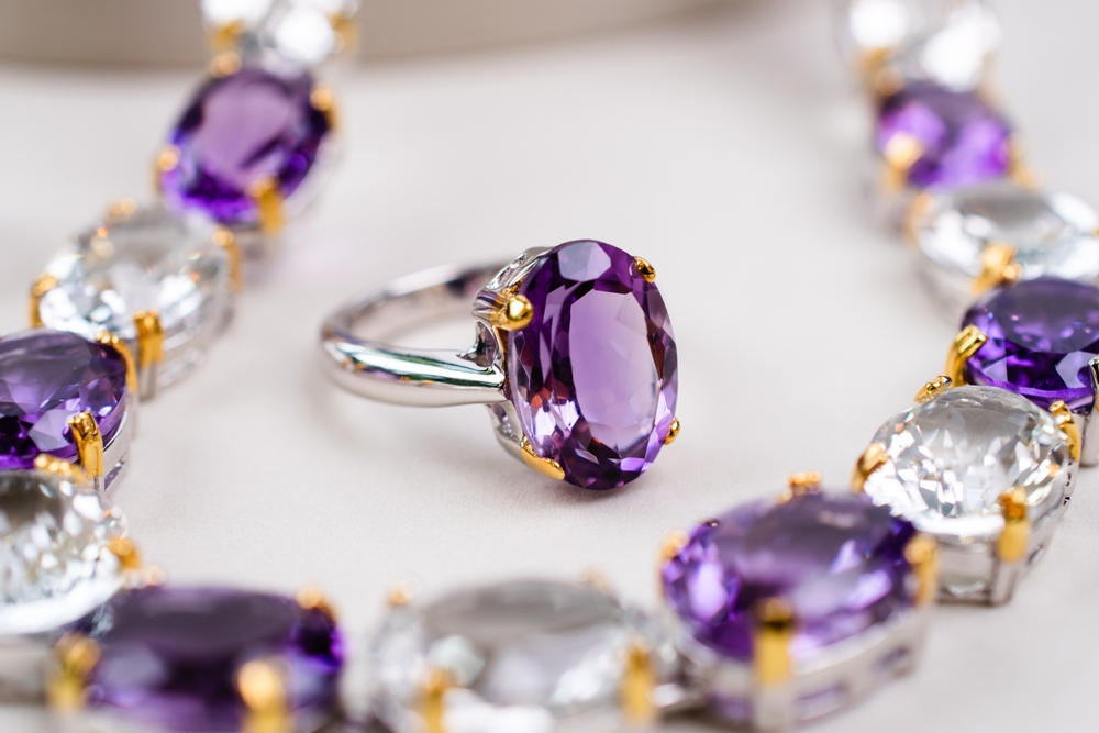 oval cut amethyst ring surrounded by an amethyst necklace