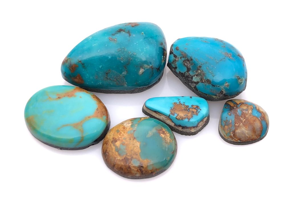 several turquoise cabochons of different sizes