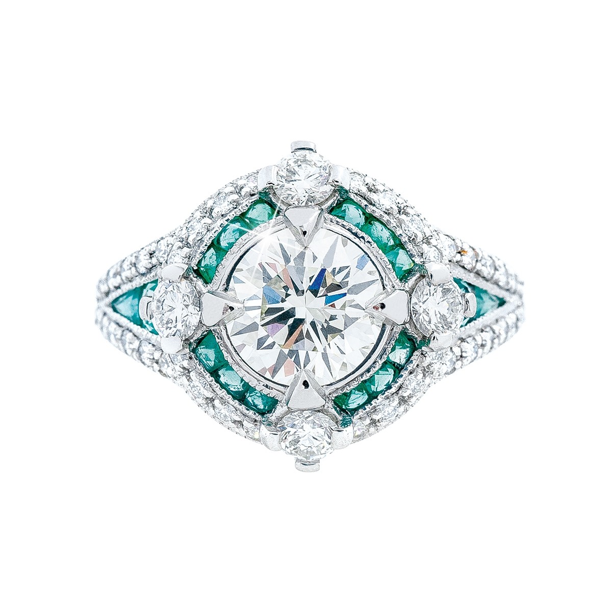 a diamond ring with diamond and emerald accents