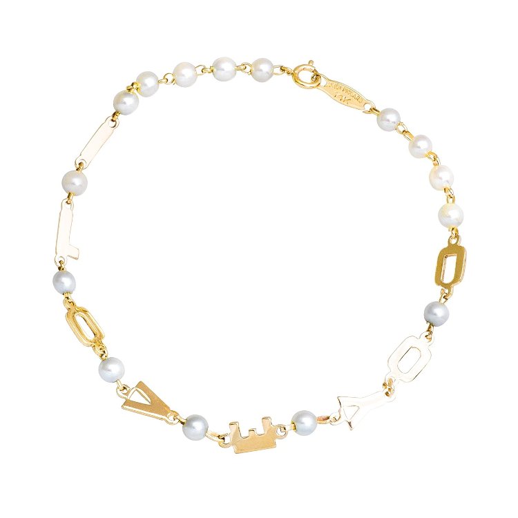 a gold and pearl bracelet that spells out LOVE