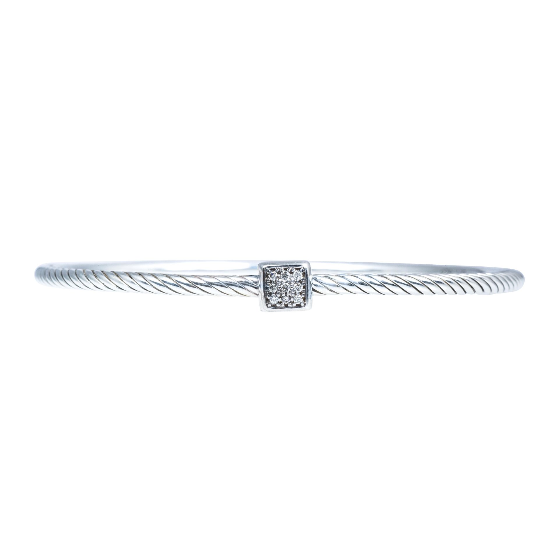 silver or white gold braided cable bracelet with one diamond set in the center