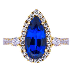 gold ring featuring a pear shaped blue sapphire with a halo of diamonds