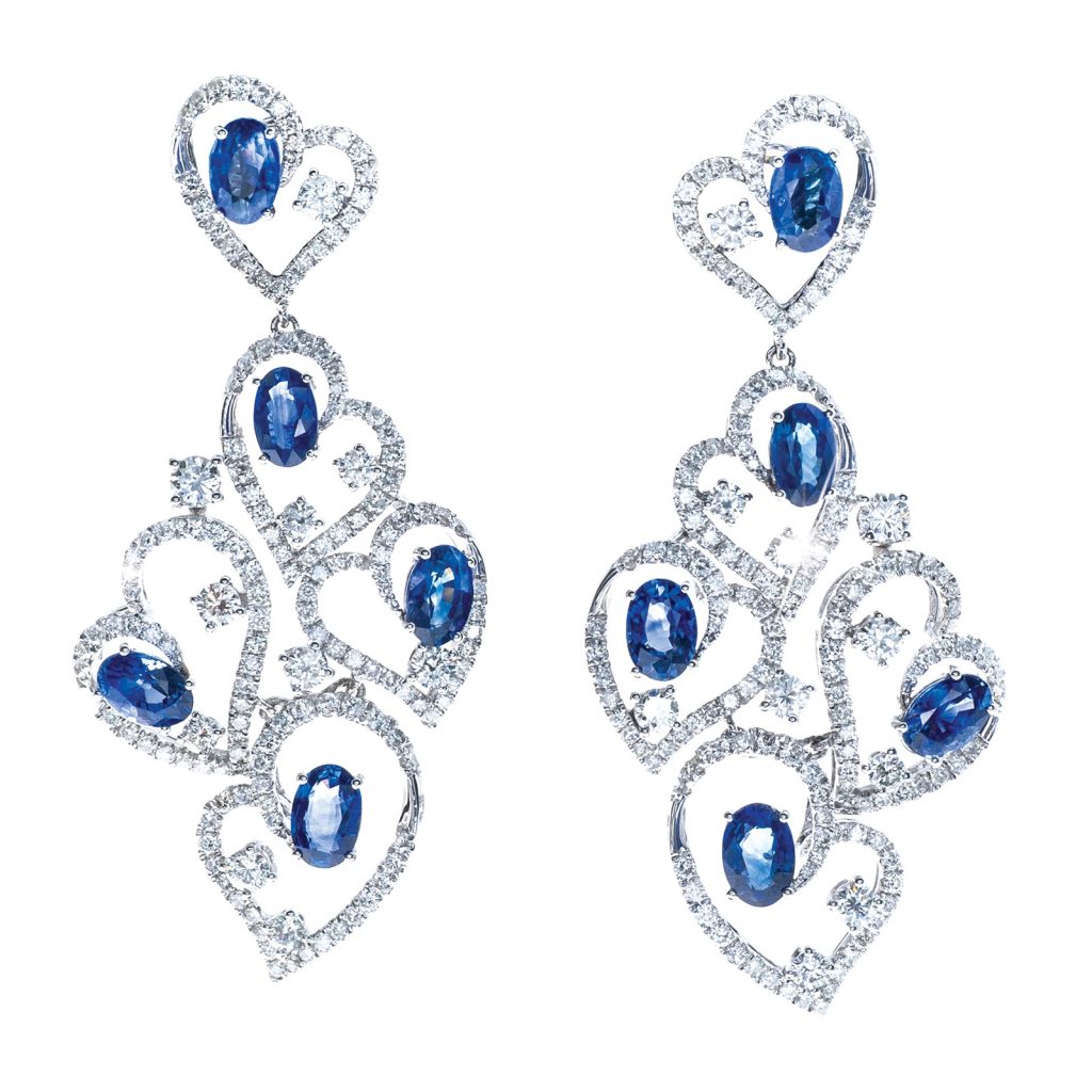 White gold heart dangle earrings set with diamond and blue sapphires.