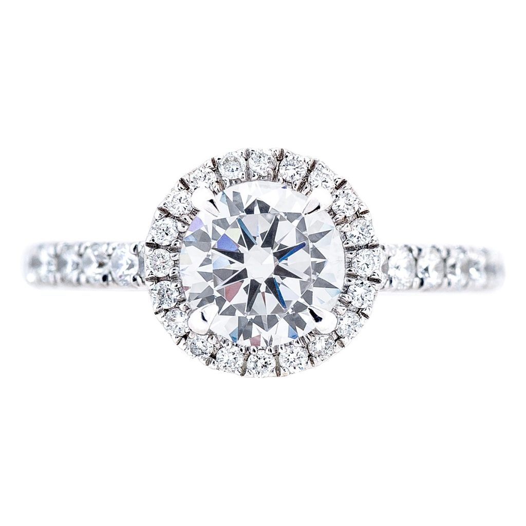 White gold diamond engagement ring with diamond halo and diamonds in the band.