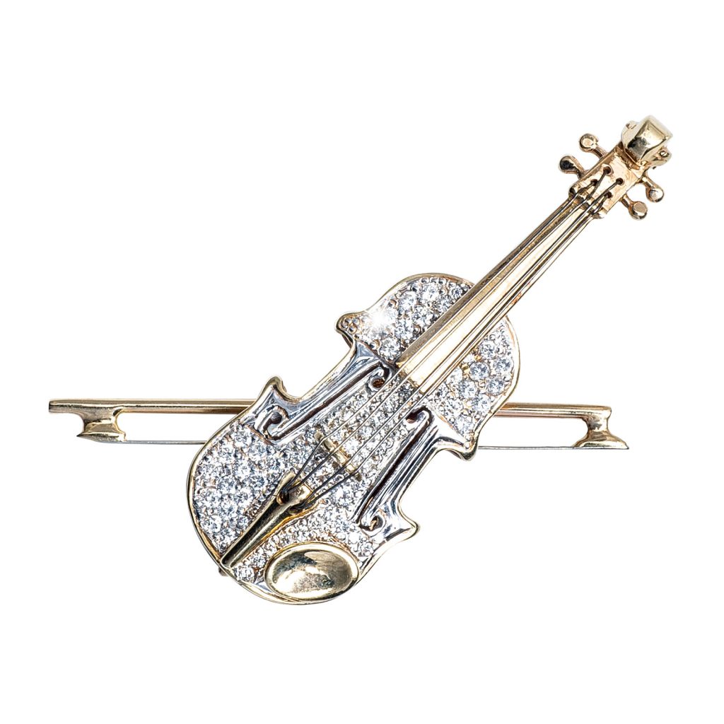 White and yellow gold violin brooch set with diamonds.