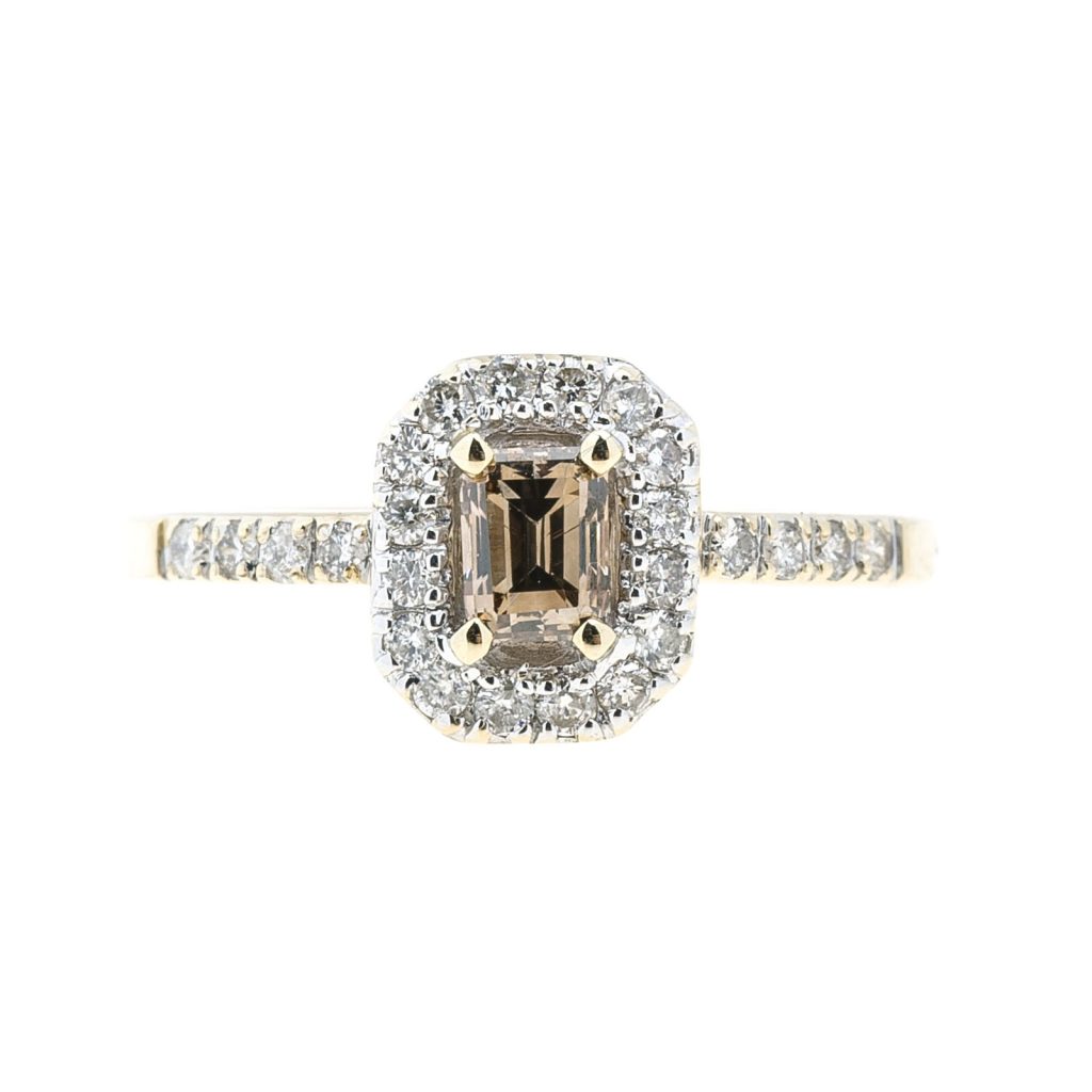 Yellow gold engagement ring centered with a cognac diamond surrounded by a white diamond halo and white diamonds in the band.