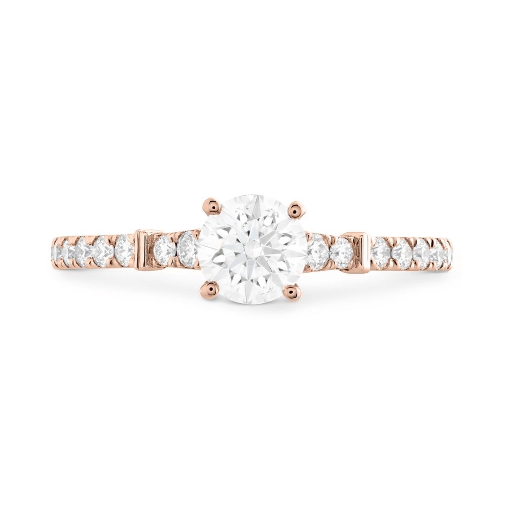 A rose gold engagement ring featuring a sparkling diamond at its center, symbolizing love and commitment.