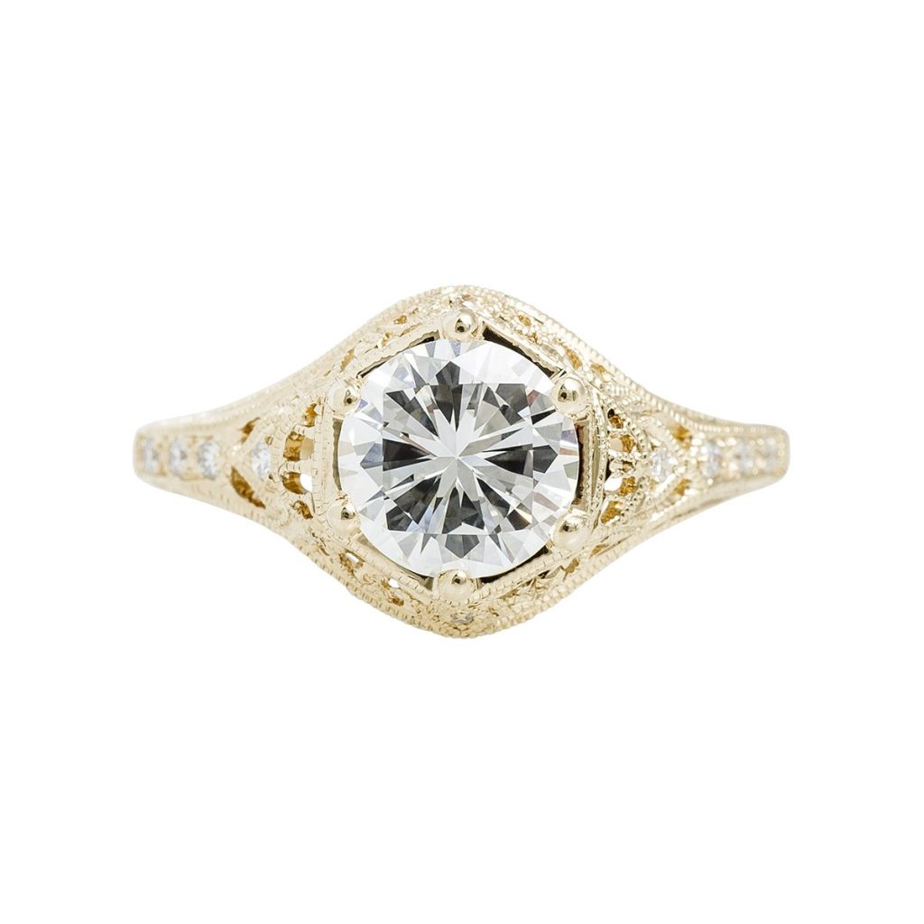 Yellow gold Art Deco diamond engagement ring with diamonds in the band.