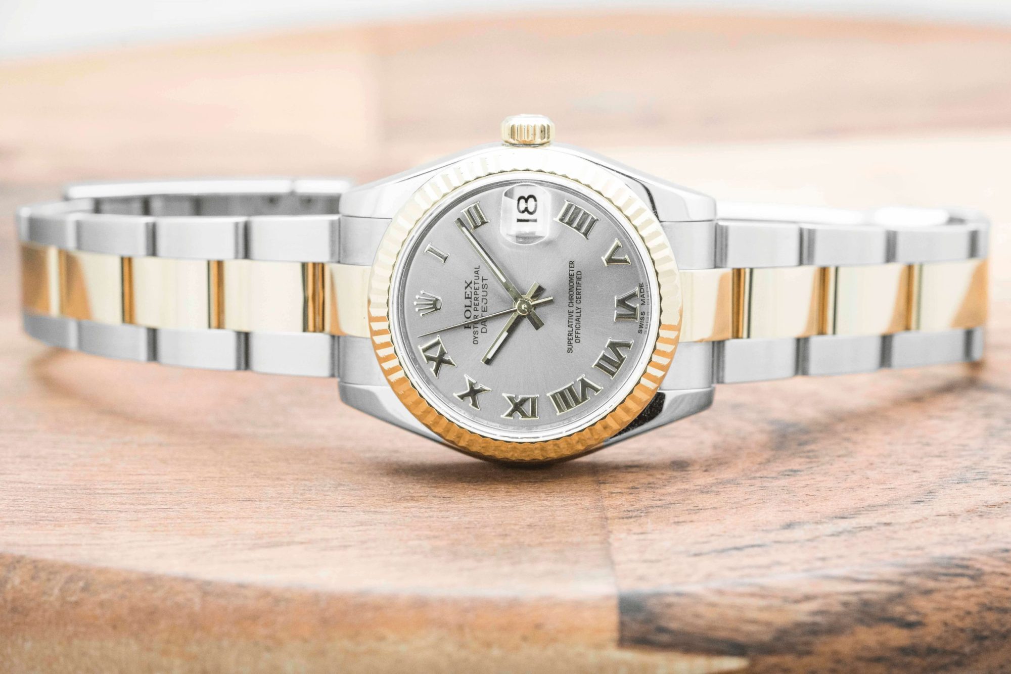 Pre-owned women’s Rolex Datejust in stainless steel and yellow gold with roman
numeral markers.