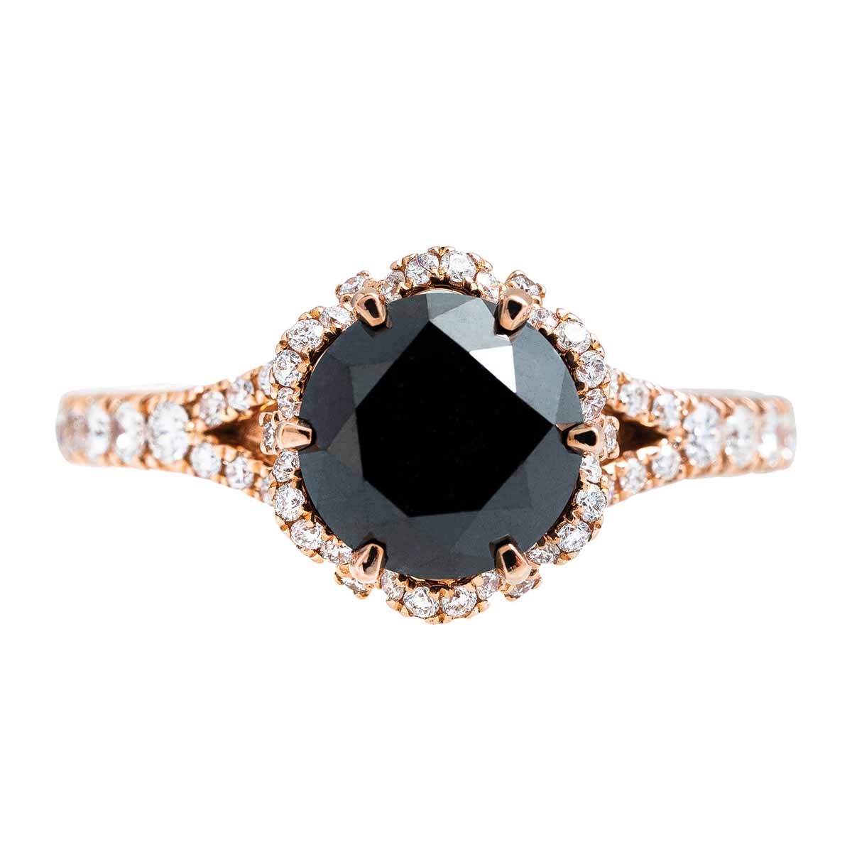 Rose gold black diamond engagement ring with a white diamond halo and white diamonds in the band.